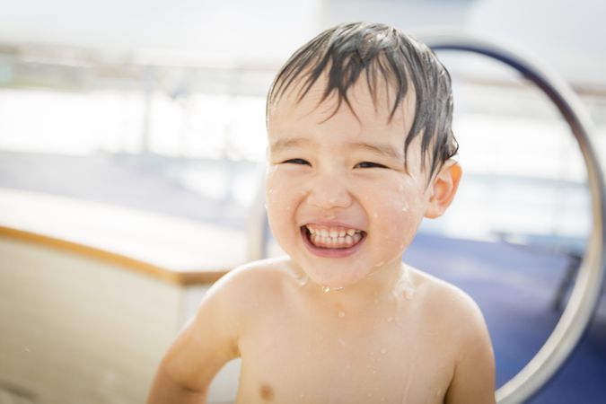 Biracial Boy Smiling and Having Fun at the Water Park