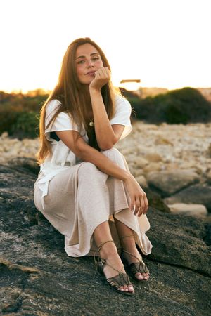 young woman posing on rock