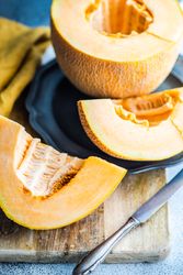 Melon on wooden cutting board