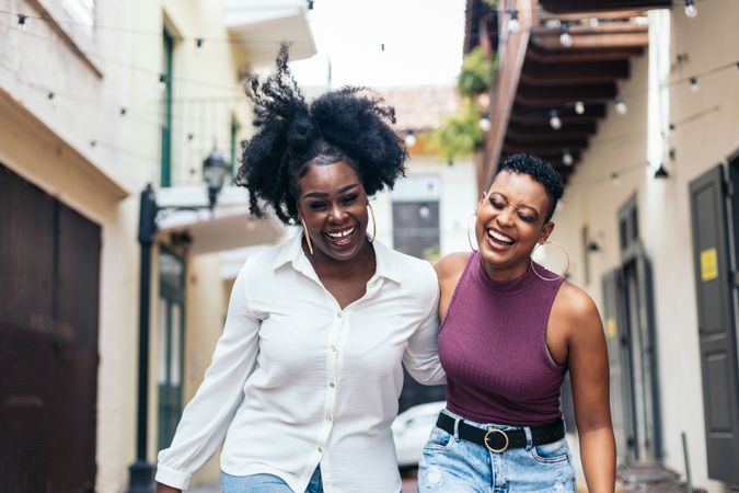 Black women talking and laughing walking in the city