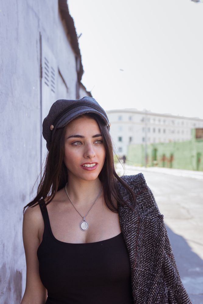 Charming Hispanic woman near wall