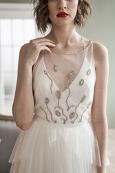 Young woman with red lips in elegant white dress looking at camera