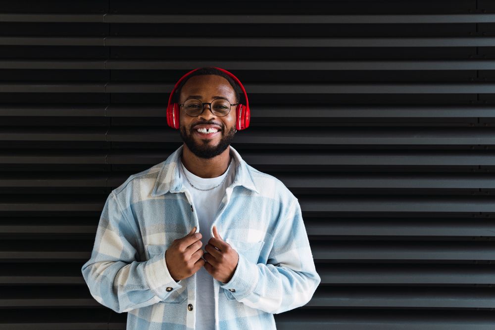 Smiling Black man in headphones and jacket