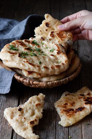 Crop man demonstrating naan bread