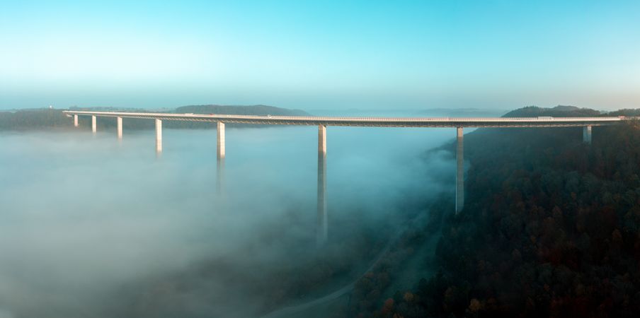 Highway bridge over dense fog, drone aerial panorama, in Braunsbach, Germany