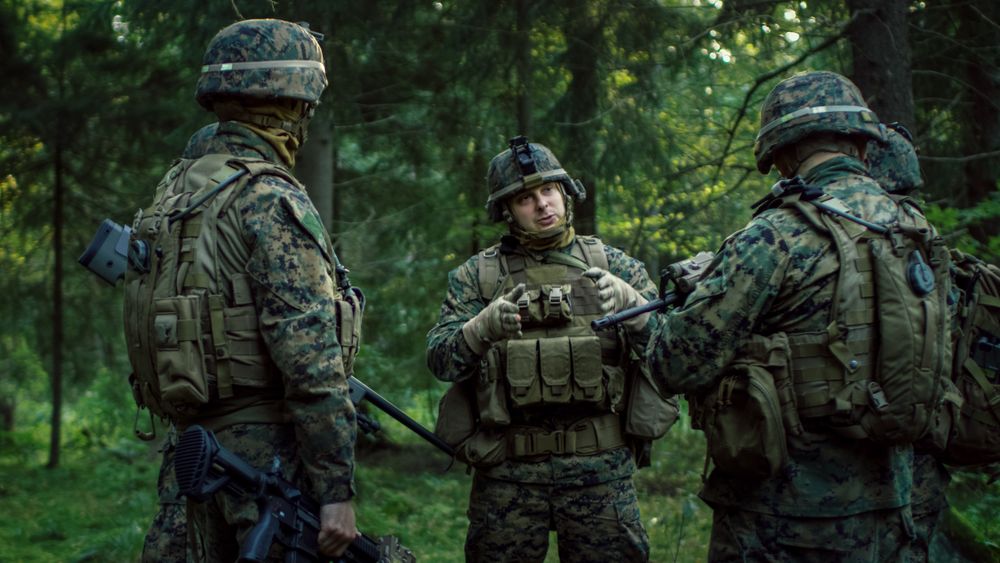 Squad Leader Discusses Military Operation Details with Soldiers, Commander Gives Orders.