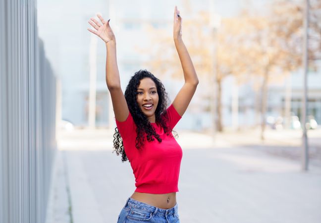A Joyful Young Woman Posing Outdoors with Unwavering Confidence and Radiant Spirit