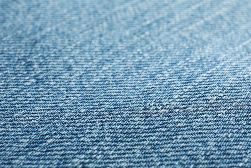 Texture of blue jeans as background, space for text