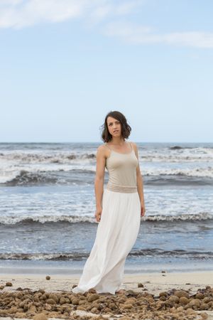 Charming young woman on shore near water