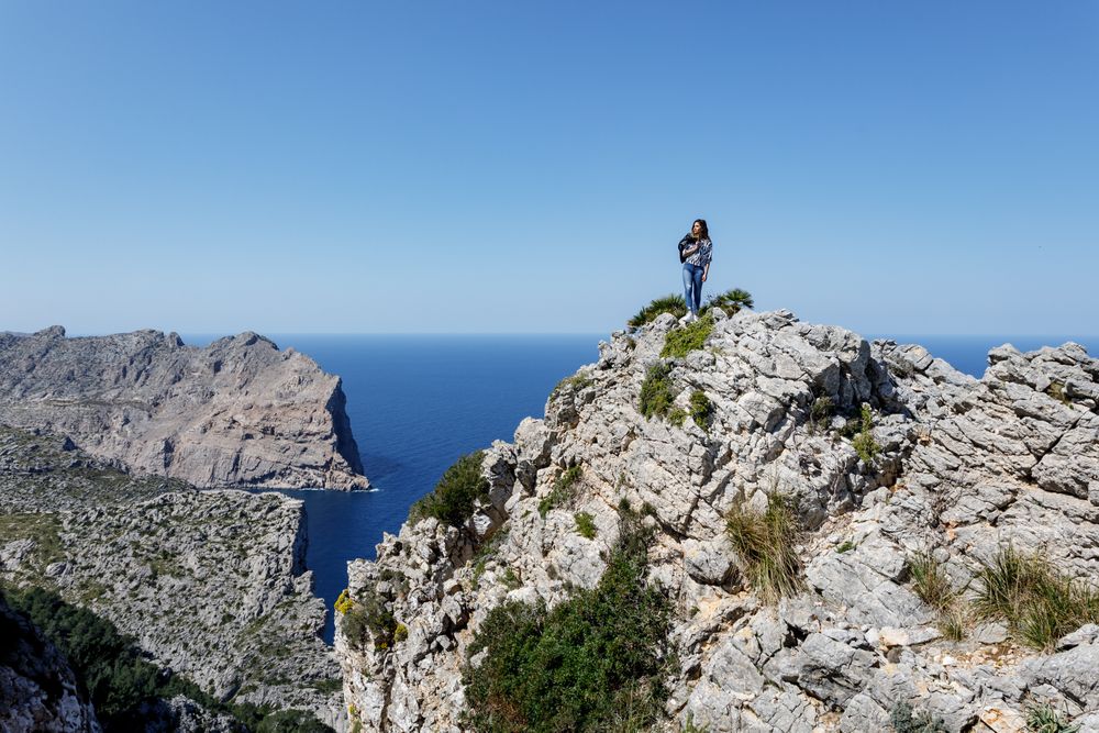 Young woman standing on cliff