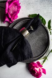 Dark summer table setting with pink roses