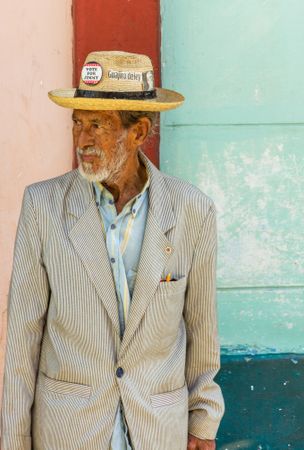 Havana, Cuba - November, 22 2012: Older male in hat on colorful background
