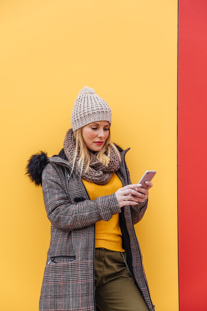Portrait of blonde woman writing on her phone