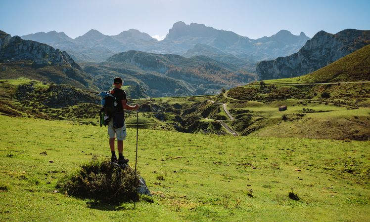 Mountaineer looking landscape with path between mountains
