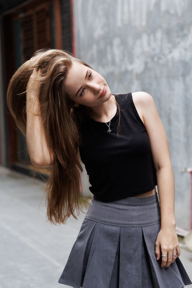 Portrait of young woman smiling and touching her hair