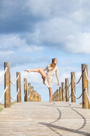 Young woman posing on footbridge