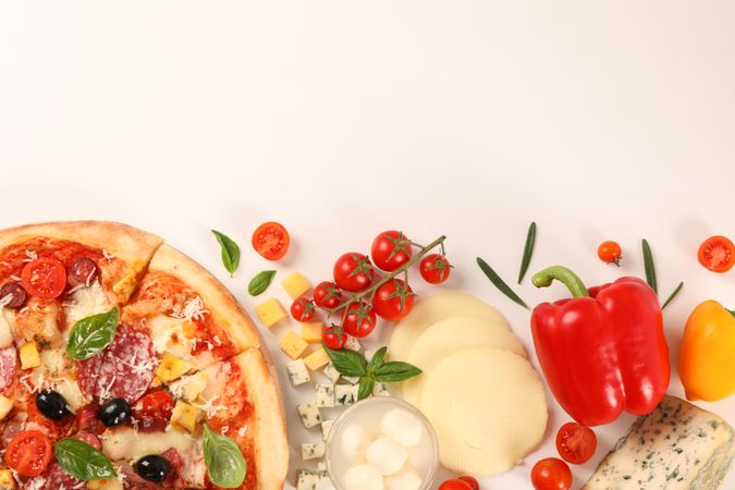 Flat lay. Pizza and ingredients: vegetables, cheese on plain background, copy space
