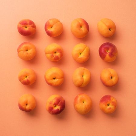 Apricots on orange background