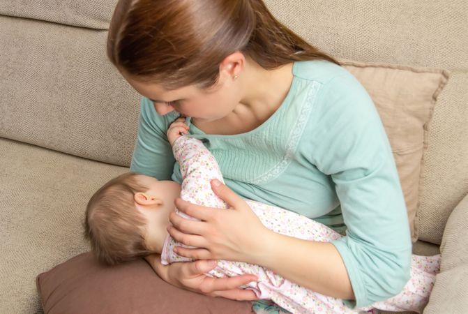 Baby breastfeeding with mother