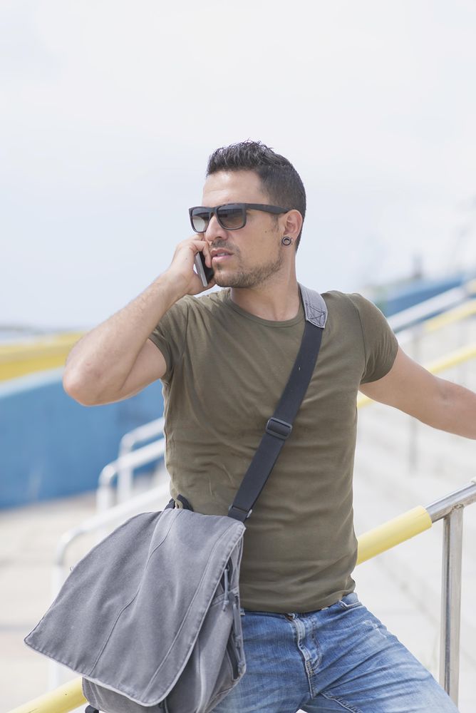 Male turning around on outdoor stairs using cellphone