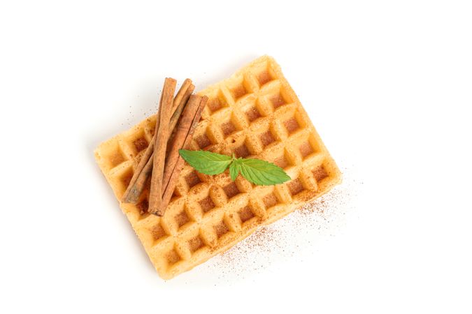 Waffle with mint and cinnamon isolated on blank background