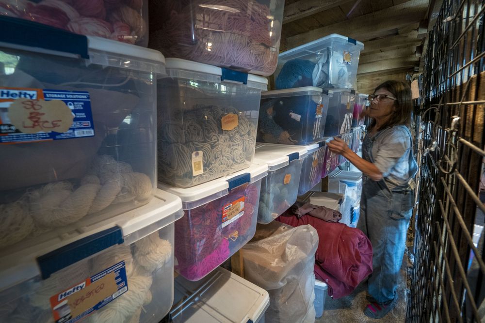Woman farmer prepares merchandise of wool and skeins to be sold