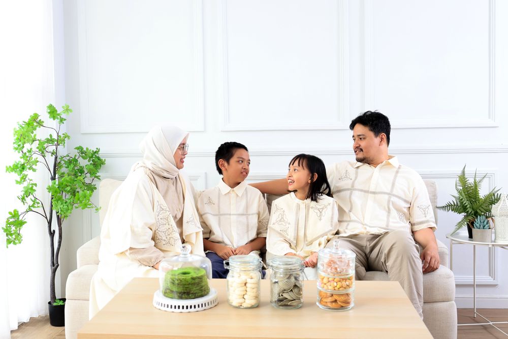 Family Sitting at Living Room Wearing Baju Lebaran Couple