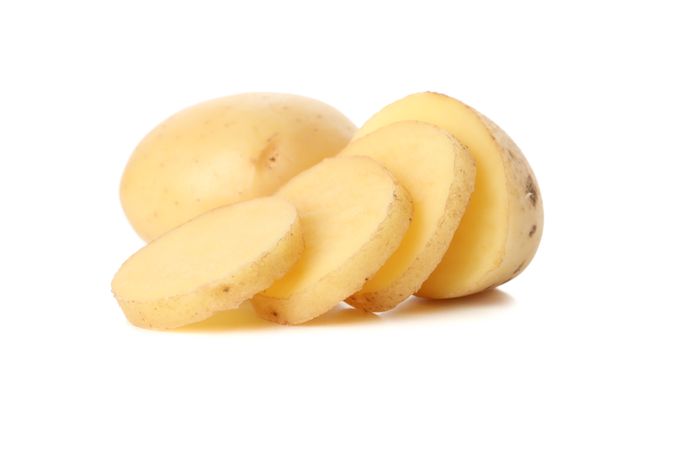 Whole and sliced potato on plain background