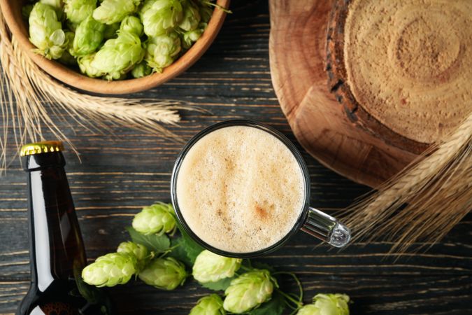 Beer, hop and wheat on wooden table