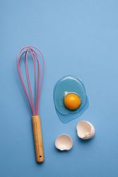 Cracked egg and whisk
