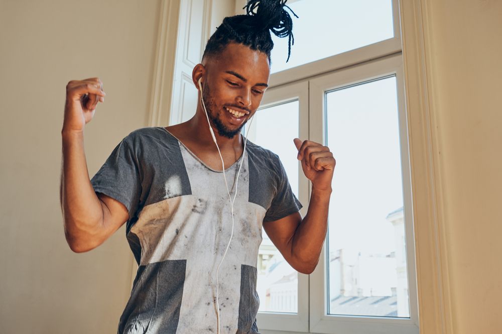 Cheerful Black male listening to music