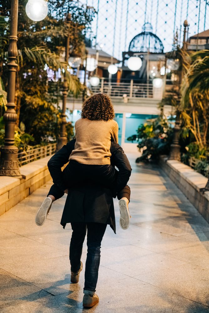 Man carrying happy girlfriend on back