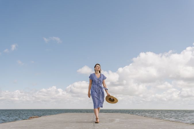 Young woman on sea wharf