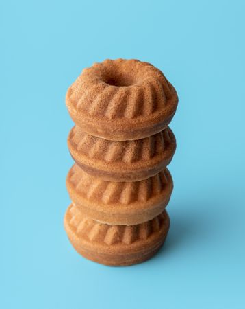 Mini bundt cakes pile on a blue background