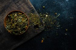 Bowl of green tea on wooden board