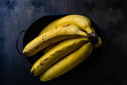 Bunch of bananas in bowl on kitchen counter