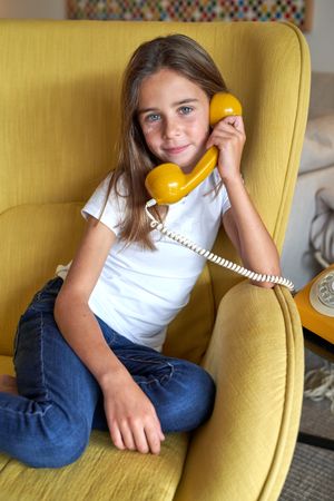 Girl talking on retro telephone