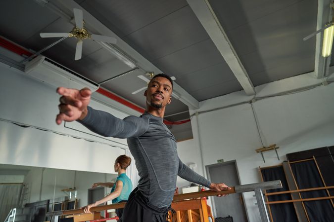 Black male dancer in a warm-up and dancing in a ballet class