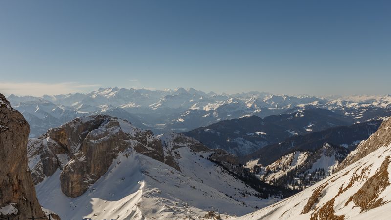 Snowy ski on mountains in sunlight