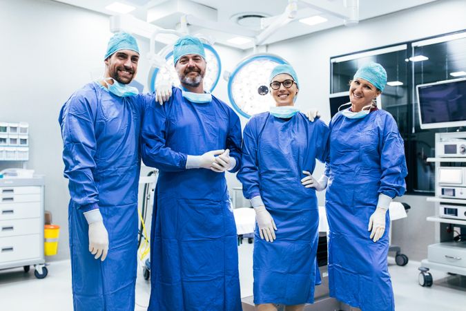 Team of surgeons standing in operating room, ready for next operation