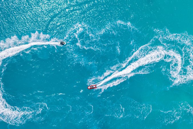Aerial shot of two jet skis in blue water