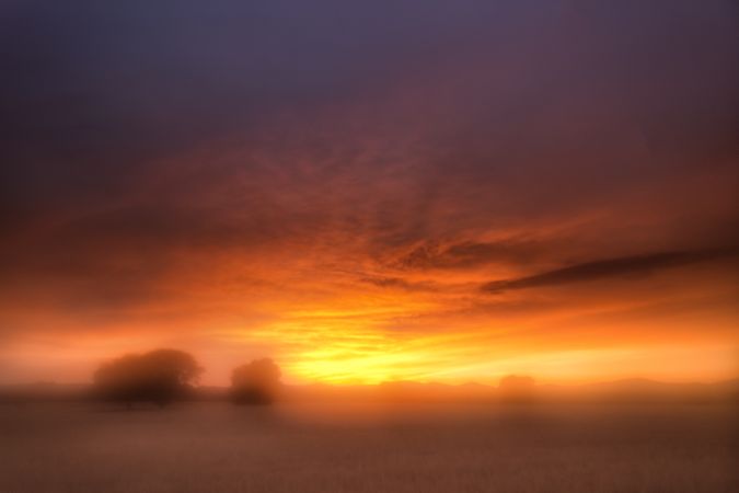 Blurry landscape of tranquil field with beautiful sunset