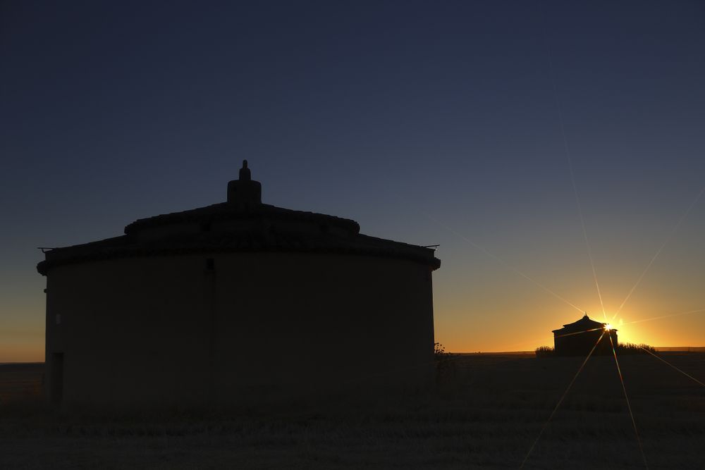 Aged house in rural countryside under starry sky