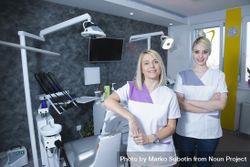 Two blonde female dentists in their bright office 0gMKA4