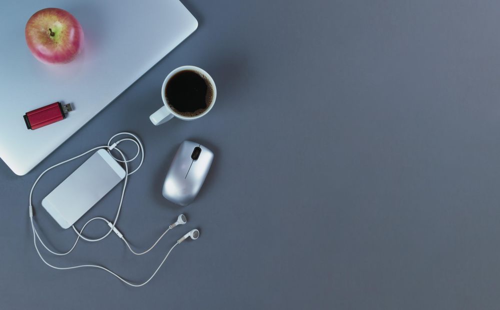 Desktop setup for teleworking with dark coffee drink