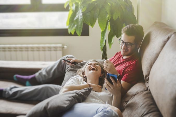 Couple with gamepads playing console