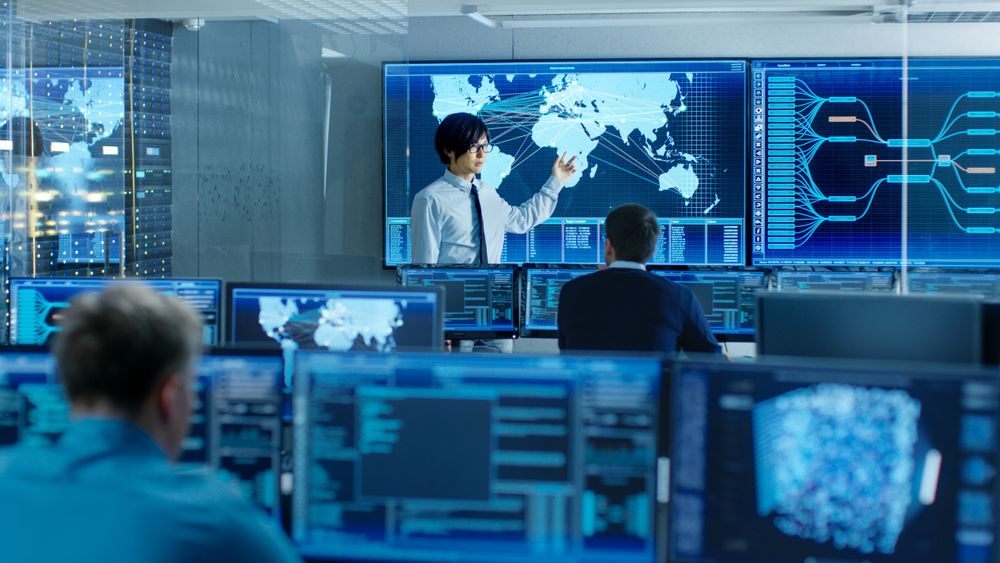 In the System Control Room Manager Holds a Briefing for His Staff Members.