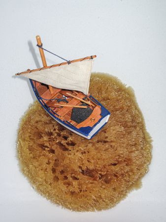 Fishing boat miniature resting on a sponge