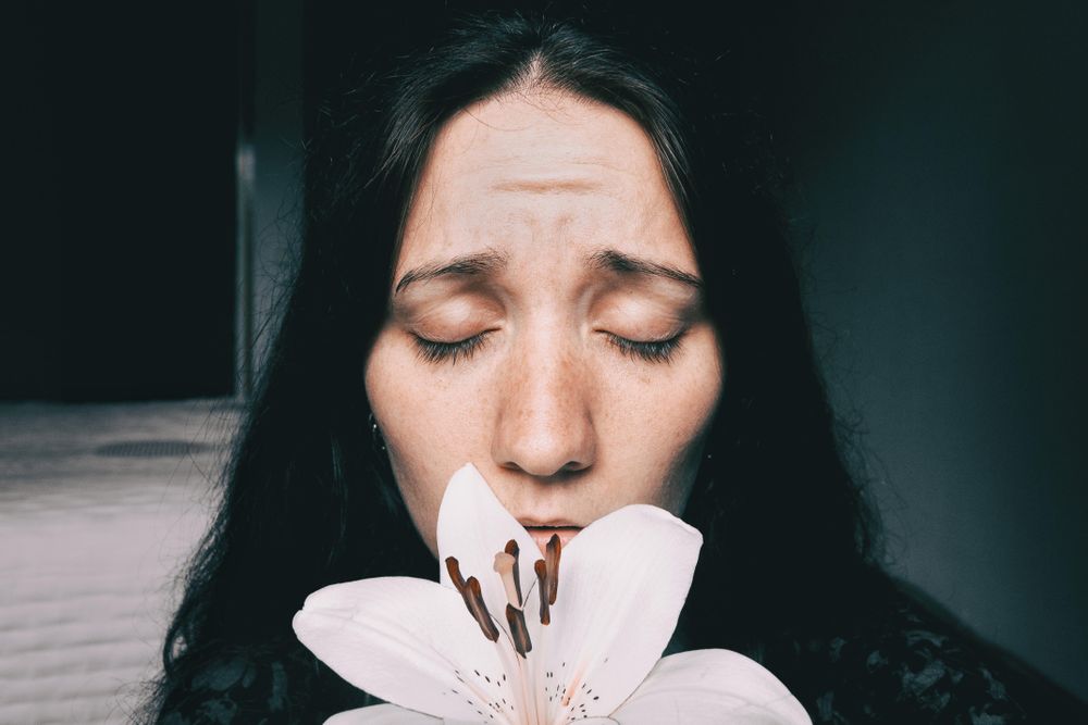 Portrait of woman with lily flower