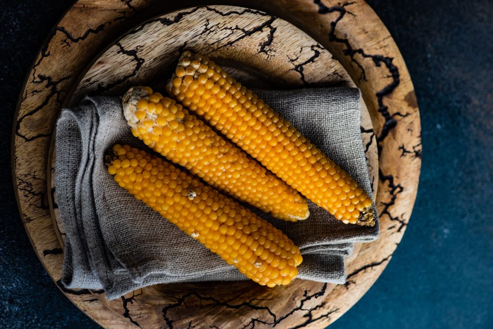 Top view of corn on the cob on rustic tableware